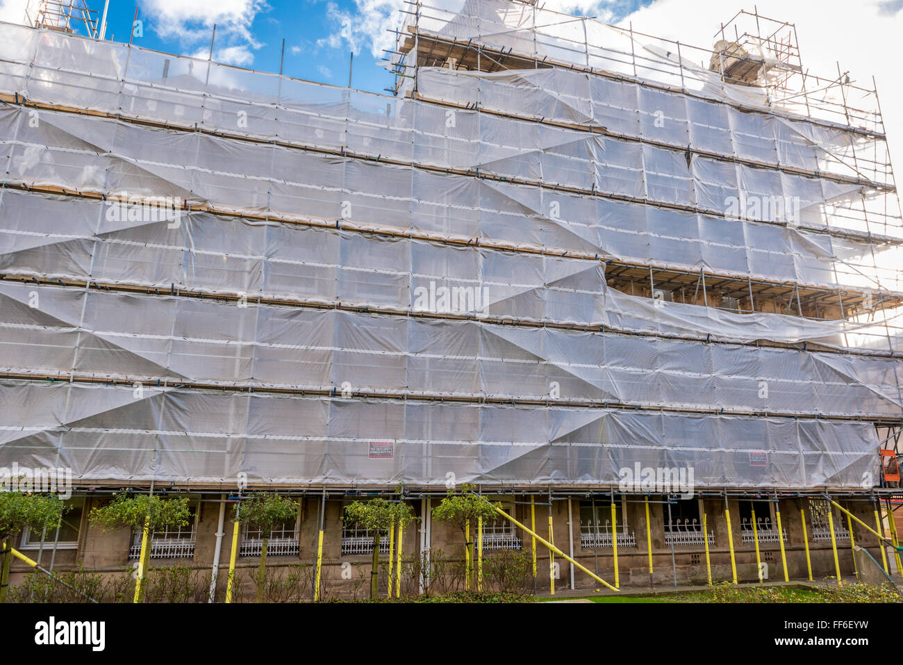 Scaffold with plastic sheet covering erected on a building Stock Photo -  Alamy