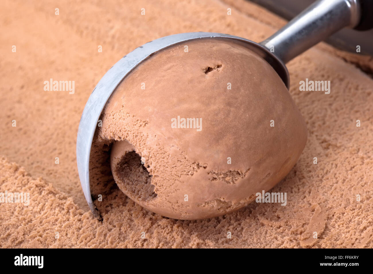Chocolate ice cream scooped out of container Stock Photo Alamy