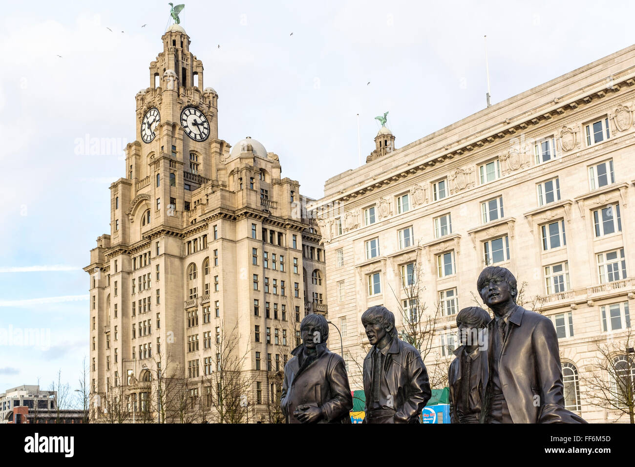 The Beatles statues at the pier head in Liverpool, UK with the Royal LIver Building in the background Stock Photo