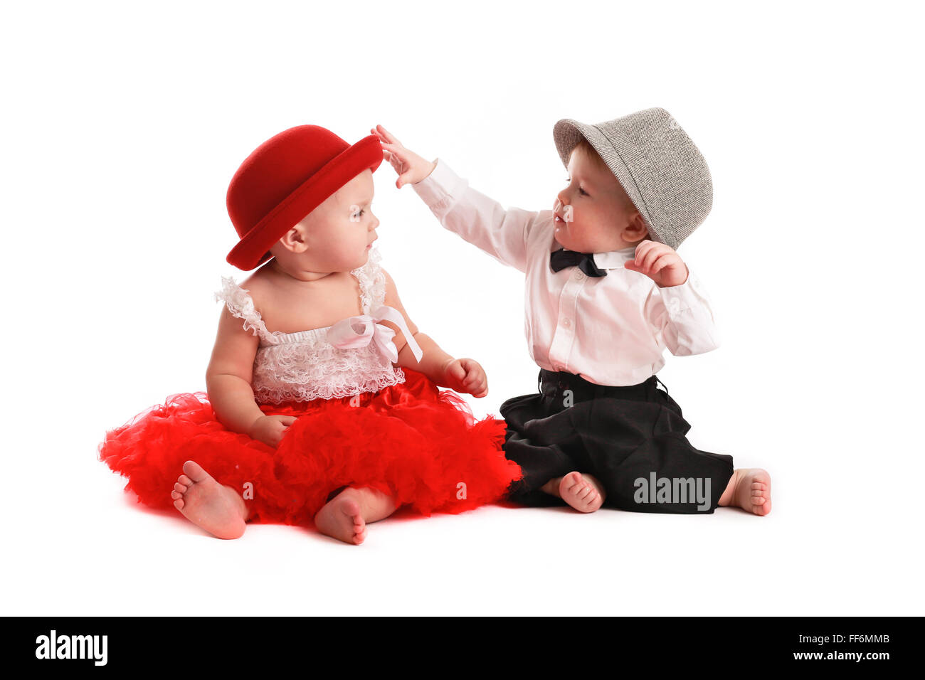 girl in a red skirt and hat boy and a gentleman in a hat, love, white background, Valentine's Day konept Stock Photo