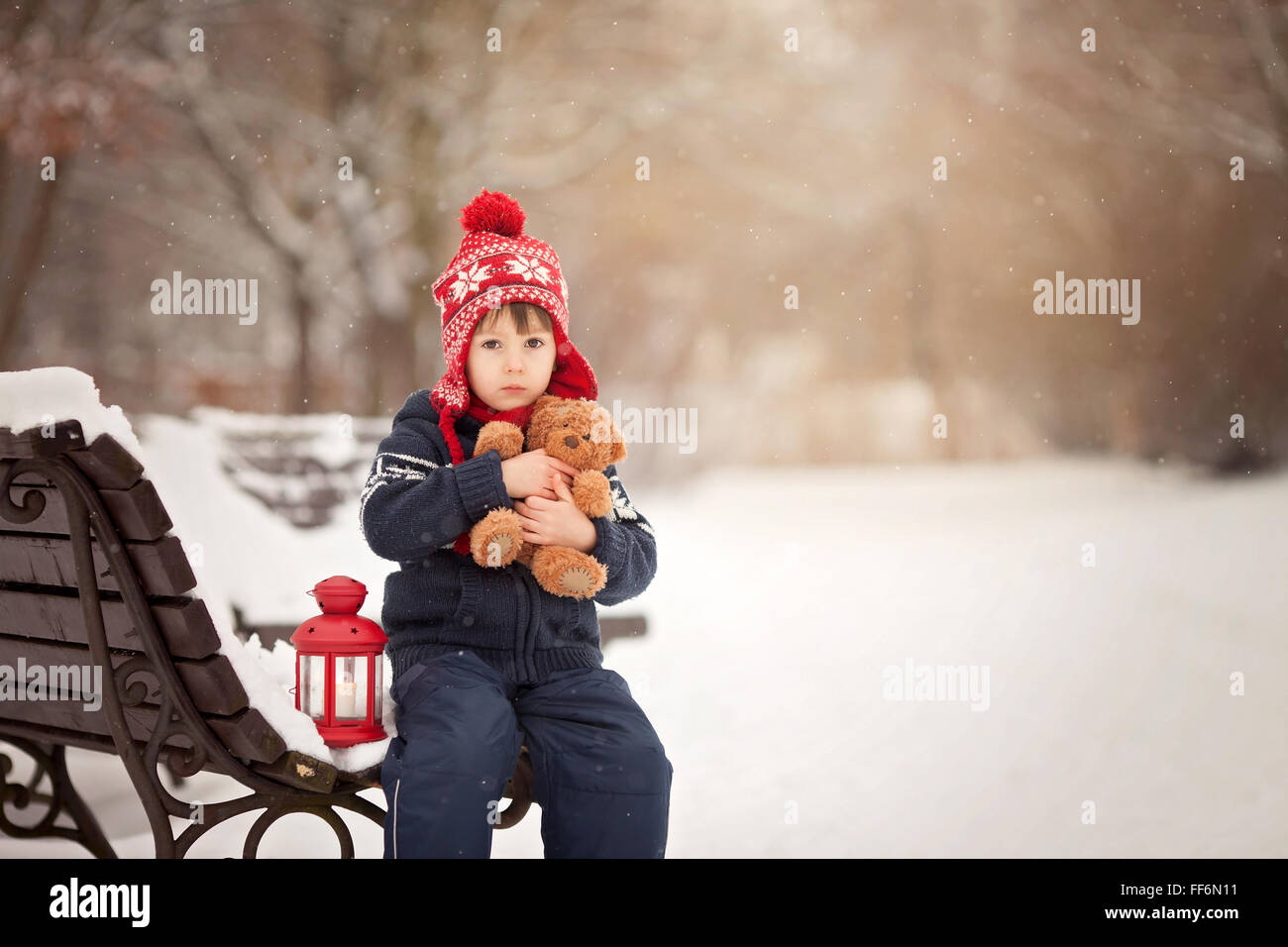 Cute little caucasian boy with teddy bear and red lantern, playing in ...