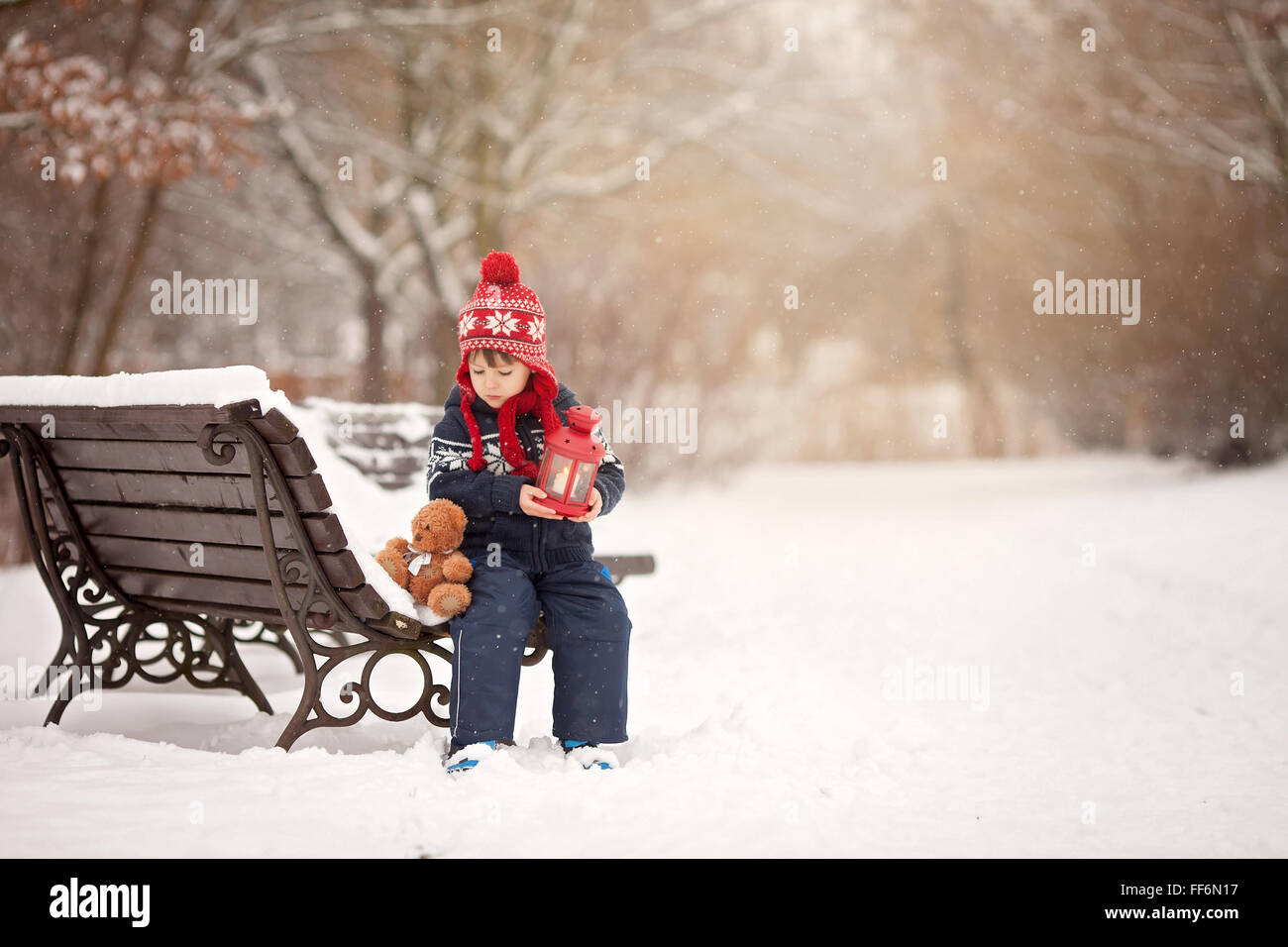 Cute little caucasian boy with teddy bear and red lantern, playing in ...