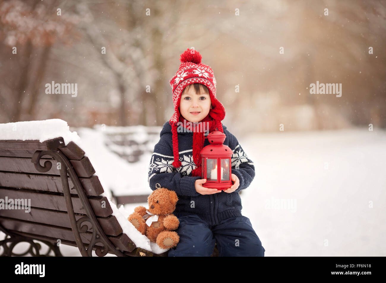 Cute little caucasian boy with teddy bear and red lantern, playing in ...