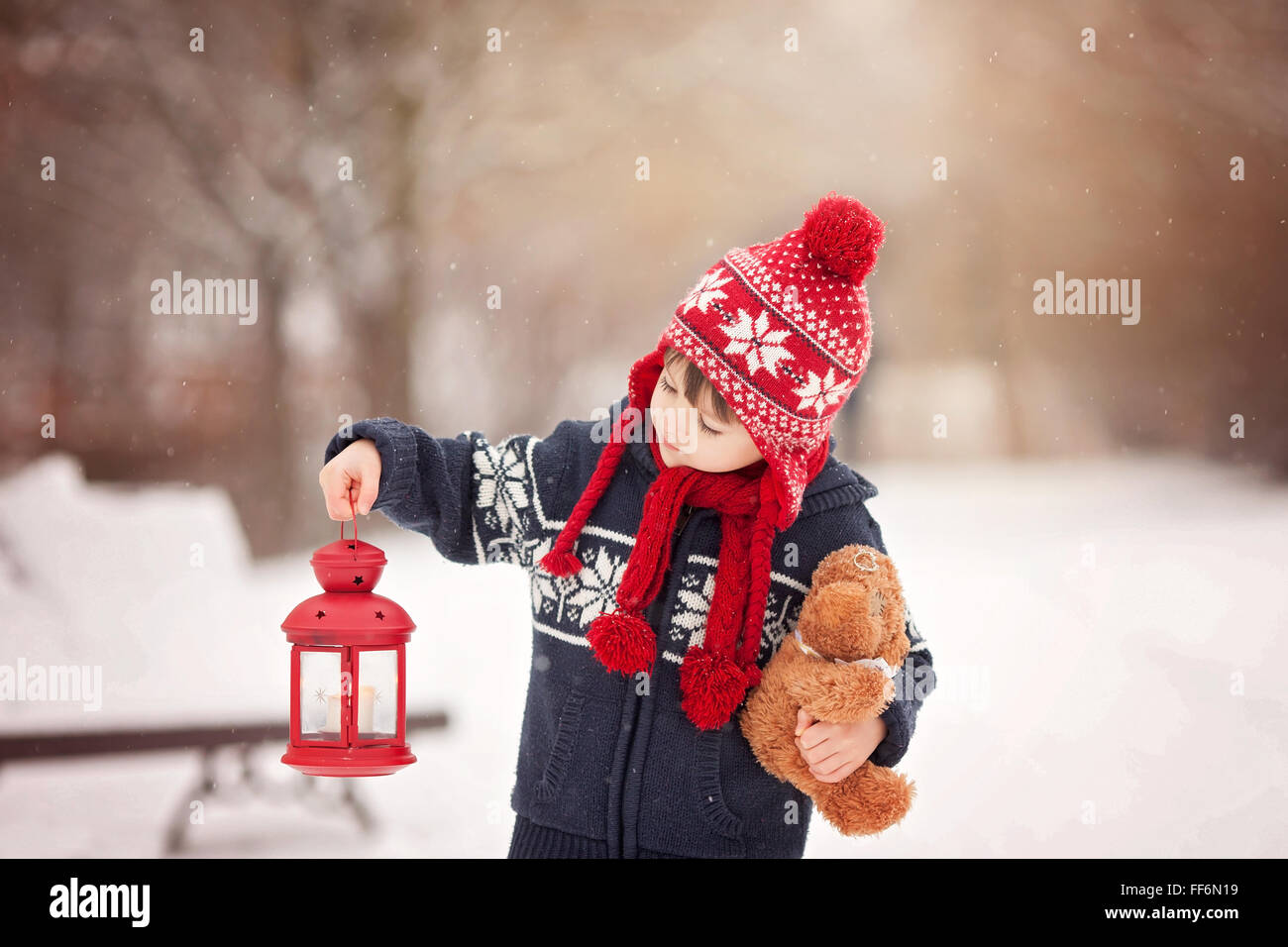 Cute little caucasian boy with teddy bear and red lantern, playing in ...