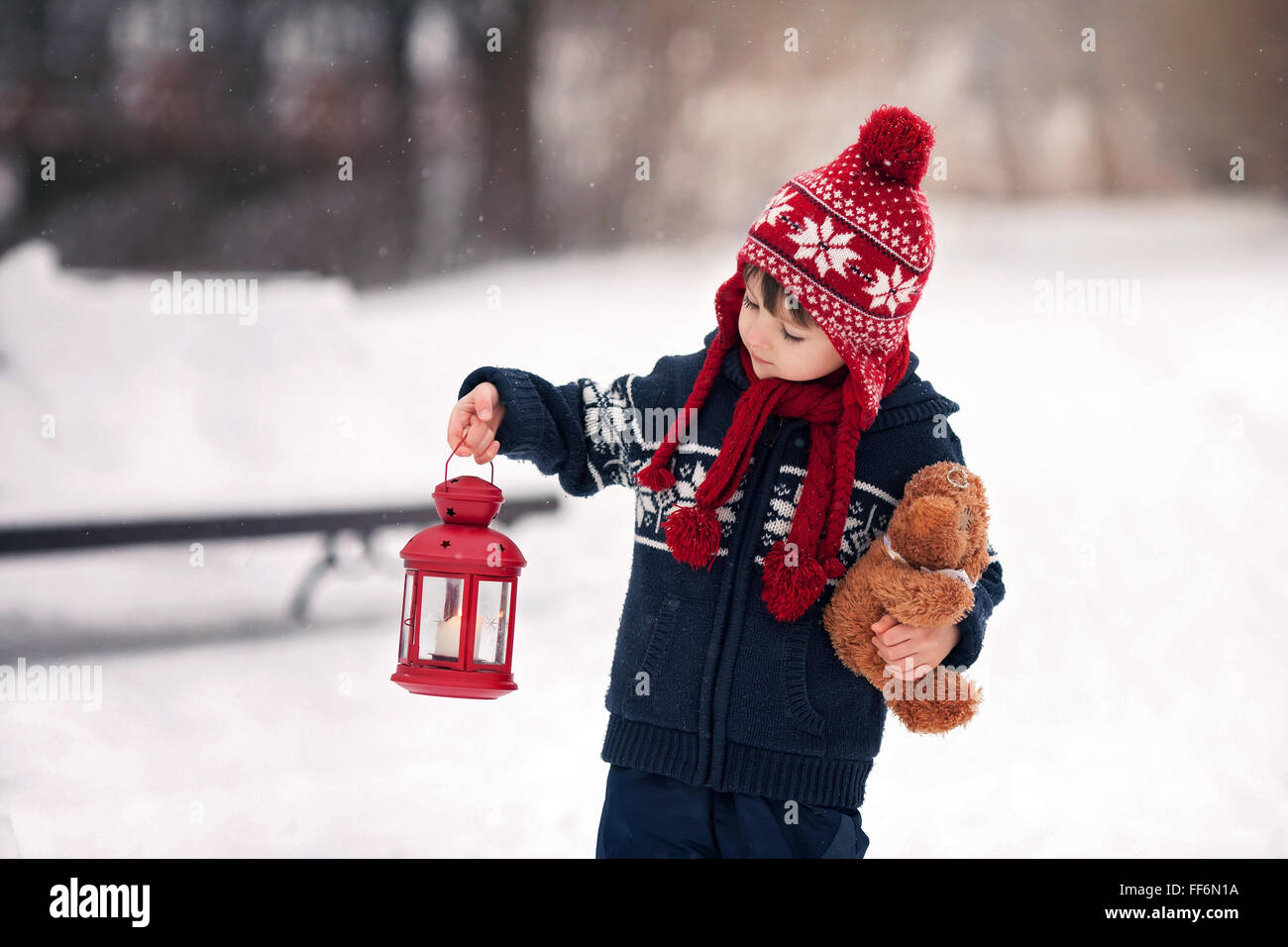 Cute little caucasian boy with teddy bear and red lantern, playing in ...