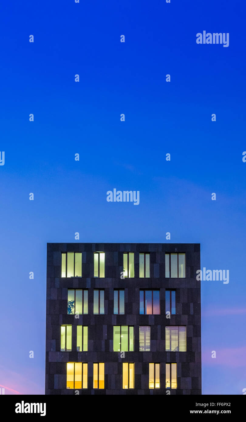 modern office building at dusk against blue evening sky Stock Photo