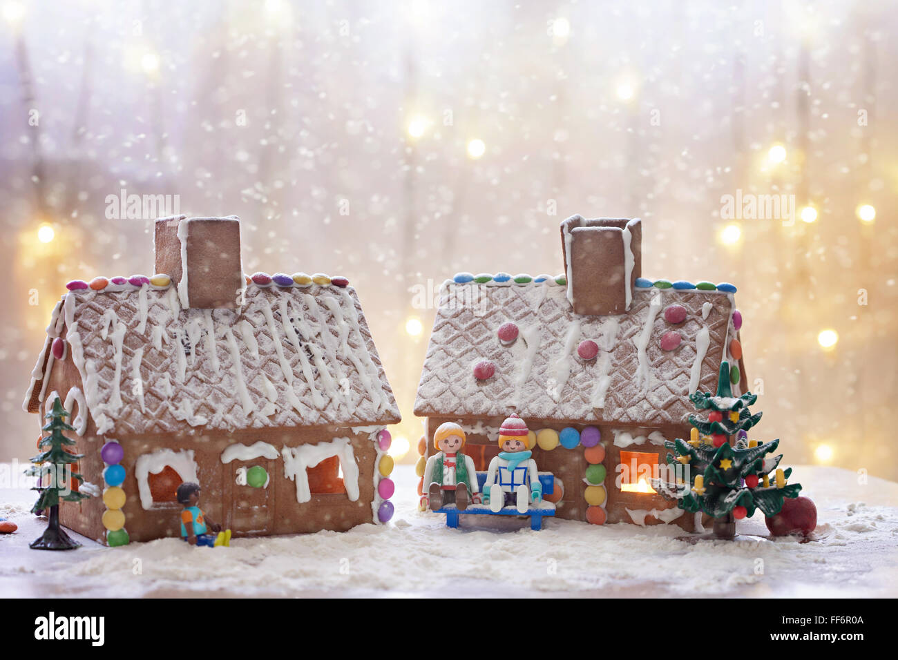 Two gingerbread houses, tree and people sitting on a bench, winter ...