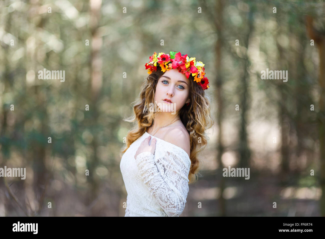 Portrait of a beautiful girl with flowers in her hair at spring time ...