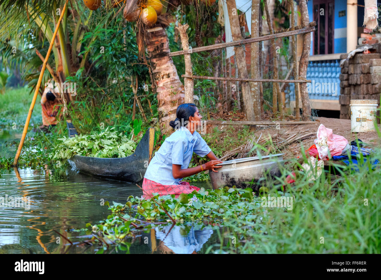 a woman doing laundry in Alappuzha, Backwaters, Kerala, South India, Asia Stock Photo