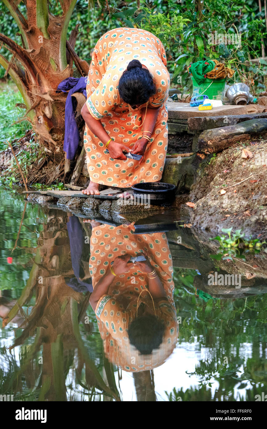 a woman preparing food in Alappuzha, Backwaters, Kerala, South India, Asia Stock Photo
