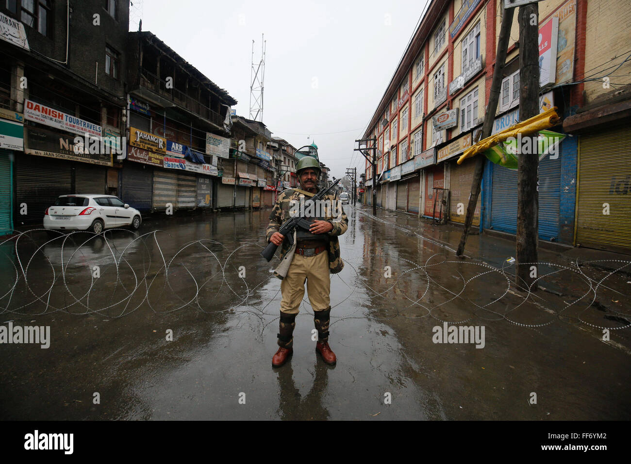 Srinagar, Indian-controlled Kashmir. 11th Feb, 2016. An Indian paramilitary trooper stands guard in Srinagar, summer capital of Indian-controlled Kashmir, Feb. 11, 2016. A shutdown call by a pro-freedom separatist group and restrictions imposed by authorities Thursday paralyzed life in Muslim majority areas of Indian-controlled Kashmir including capital Srinagar, officials and residents said. The shutdown was called to mark 30-second hanging anniversary of the region's topmost separatist leader Mohammed Maqbool Bhat. Credit:  Stringer/Xinhua/Alamy Live News Stock Photo