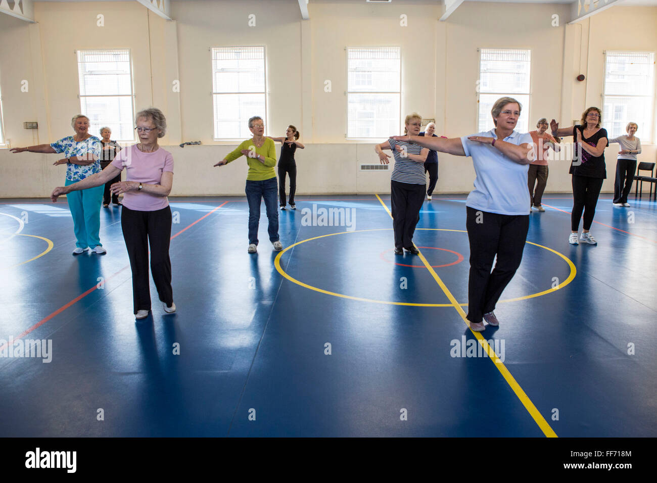 Local elderly members of the community take part in an exercise class at the Percy centre, Bath Somerset. Stock Photo