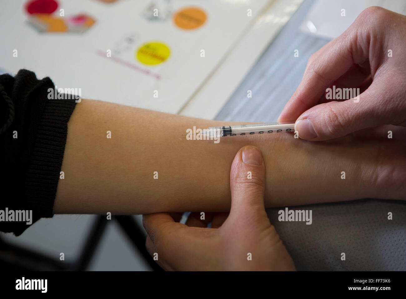 Sarah Murphy, TB Nurse Specialist, performs an intra-dermal injection of the Mantoux PPD skin test on a young person’s forearm to screen for Latent TB infection. London, UK. Stock Photo