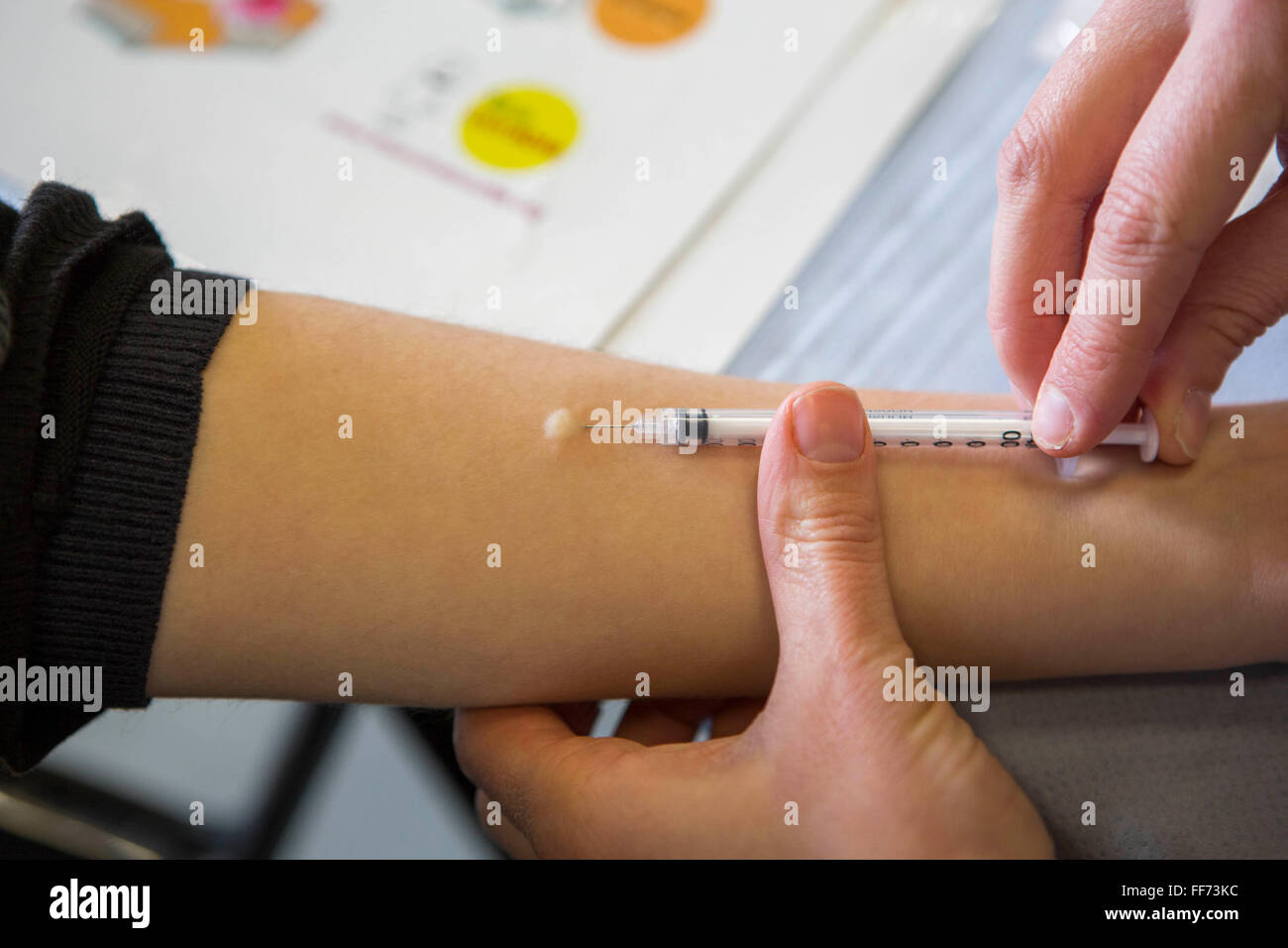 Sarah Murphy, TB Nurse Specialist, performs an intra-dermal injection of the Mantoux PPD skin test on a young person’s forearm to screen for Latent TB infection. London, UK. Stock Photo