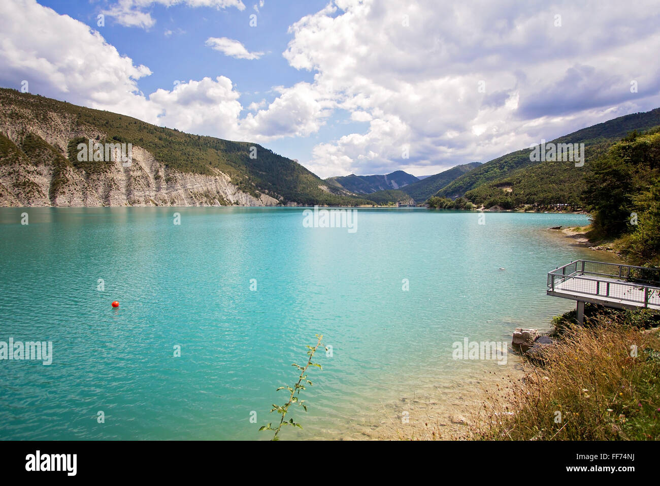 Beautiful emerald green water of Lake Castillon reflects the sky and ...