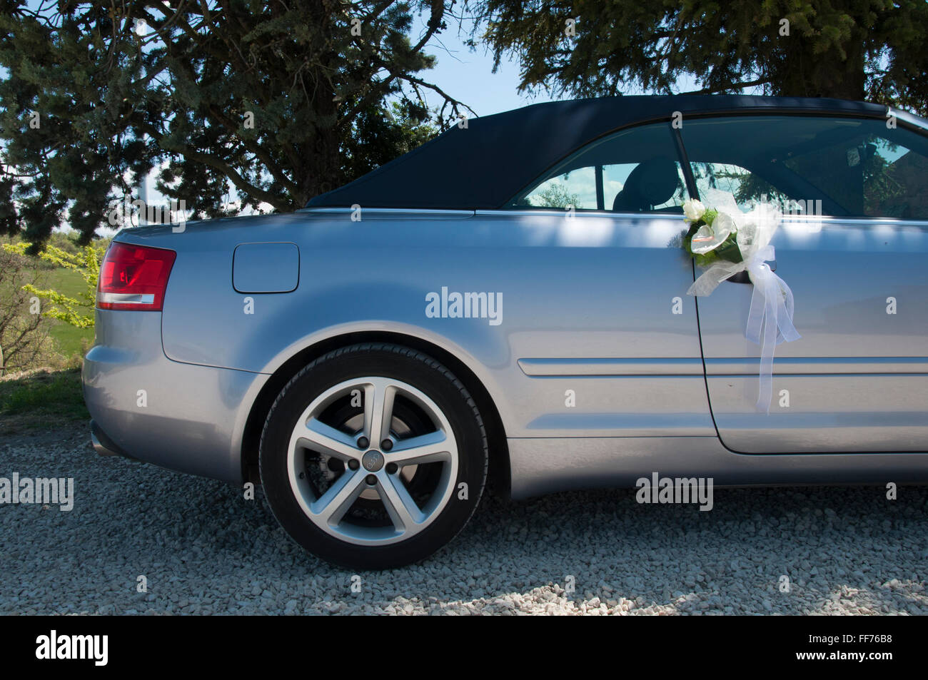 Wedding flowers hanging from the mirror of a car audi Stock Photo