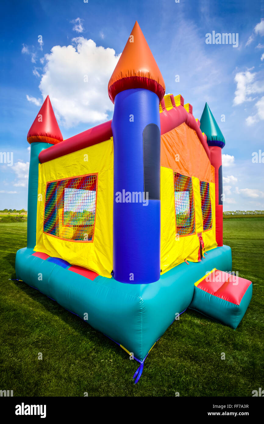 Bounce house inflatable jumpy castle in a large open yard Stock Photo - Alamy