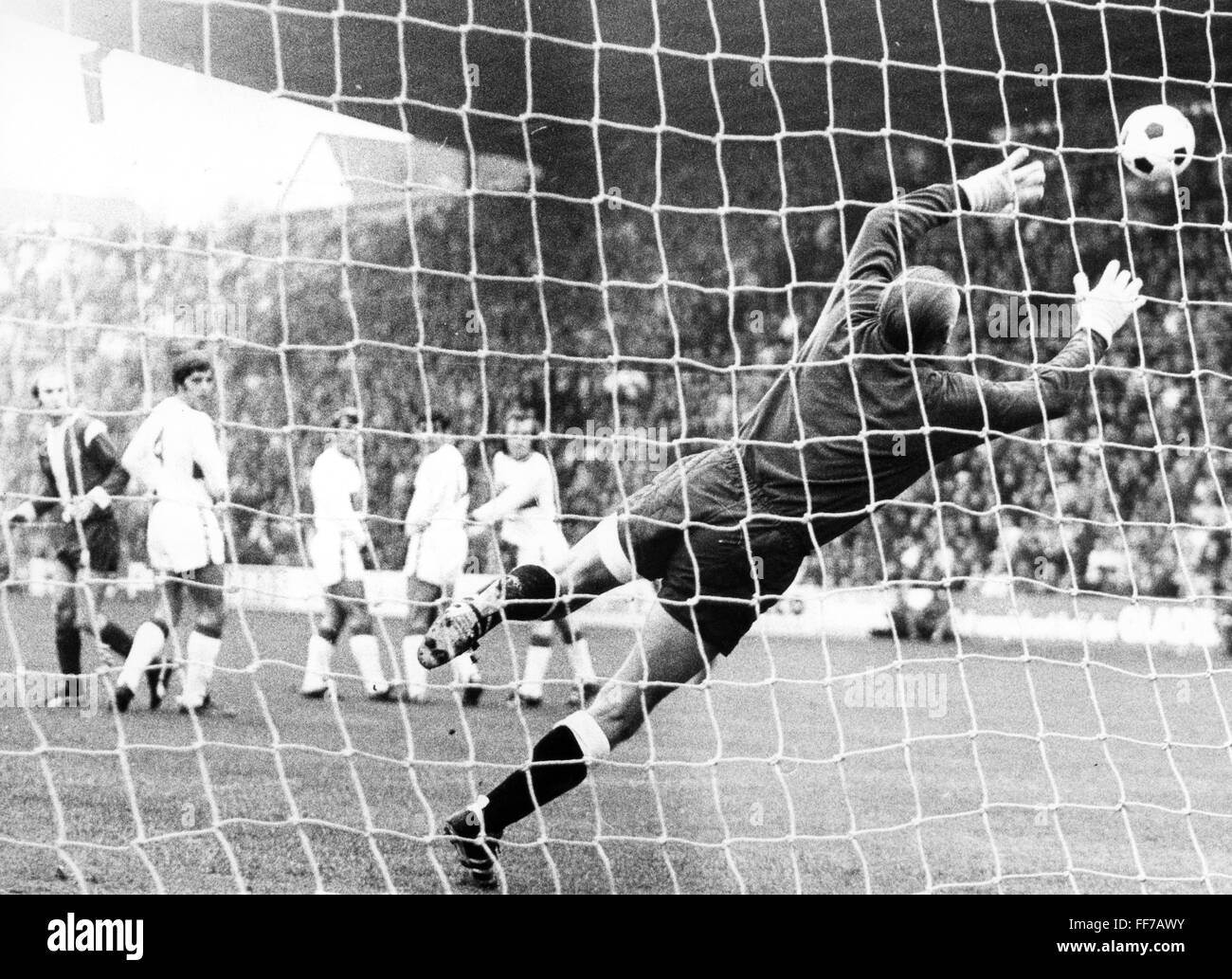 sports,football,game,Germany,national league,season 1970 / 1971,13th match day,game Borussia Moenchengladbach versus VFB Stuttgart(4:1),goal to the 1:0 after free kick of Guenter Netzer,unsuccessful save of goal keeper Gerhard Heinze,Boekelberg stadion,Moenchengladbach,31.10.1970,goal,goals,goal net,net,nets,football player,football players,footballer,footballers,kicker,action,act,actions,acts,jumping,jumps,jump,ball,sports stadium,sports stadiums,football stadium,soccer stadium,football stadiums,soccer stadiums,Saturday,a,Additional-Rights-Clearences-Not Available Stock Photo