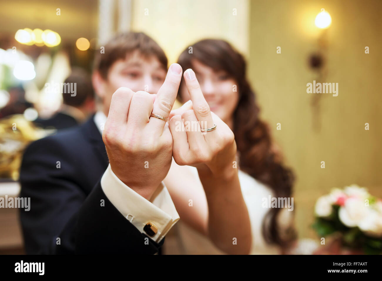 The bride and groom show wedding rings on fingers Stock Photo
