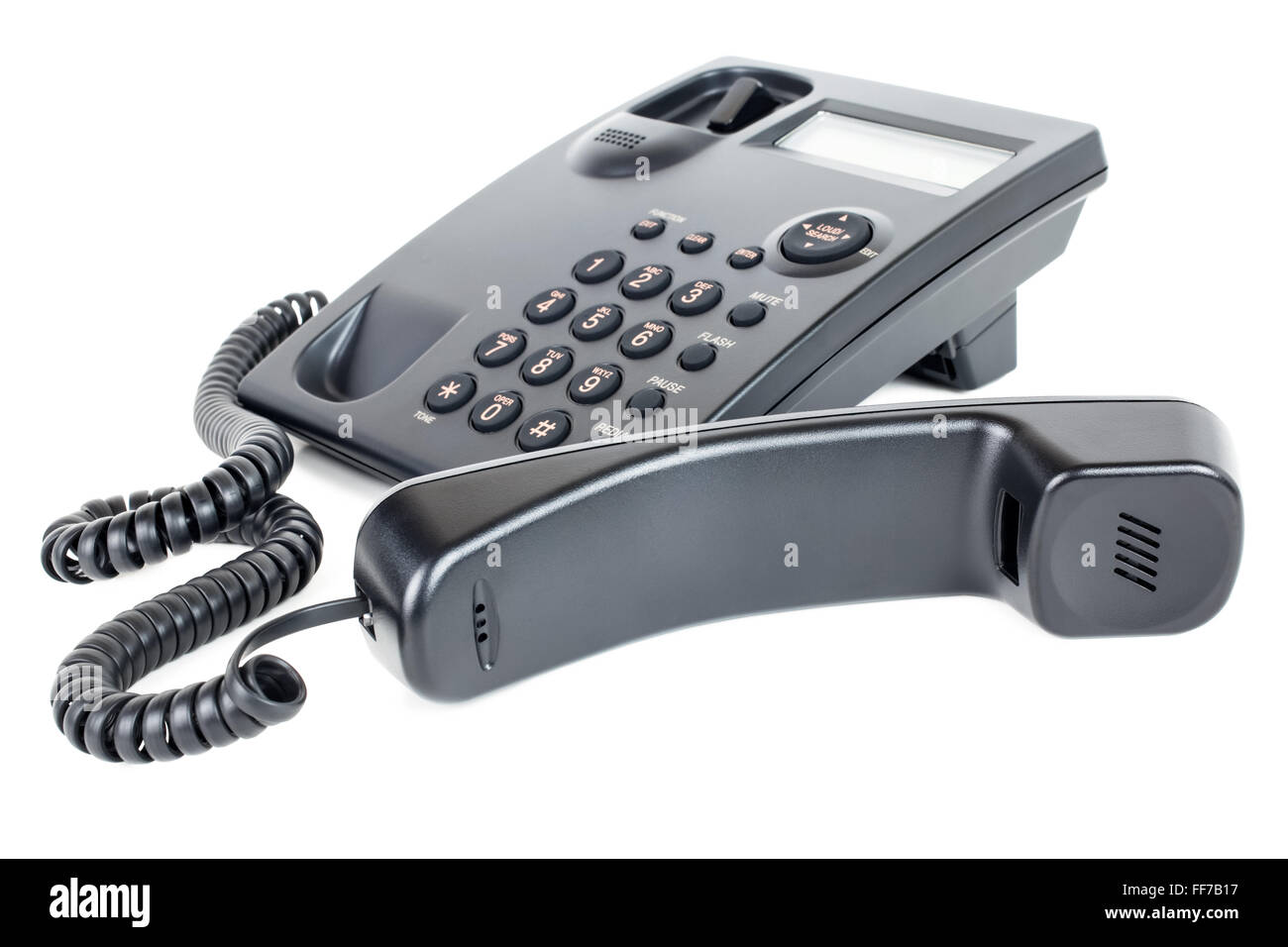 Picture of a business landline telephone with the receiver off the hook laying in front of the phone Stock Photo