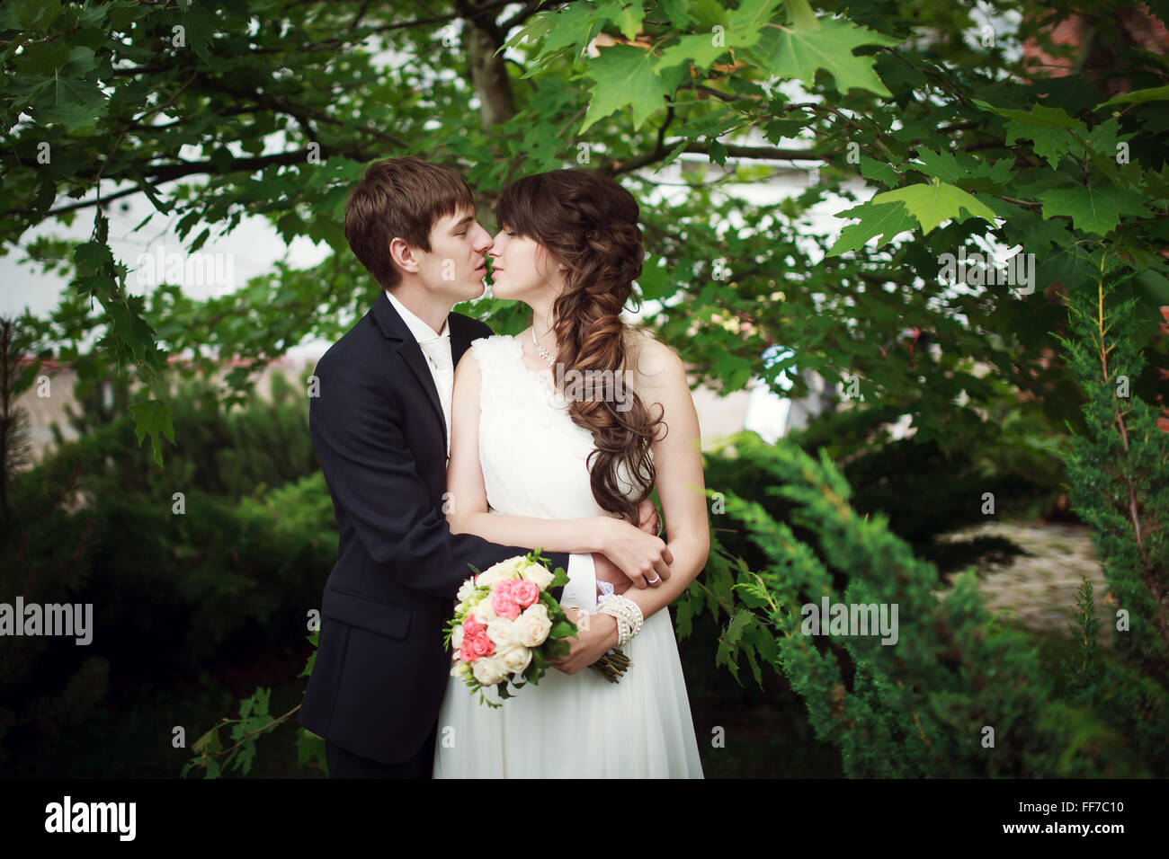 The groom kisses his bride on their wedding day Stock Photo - Alamy