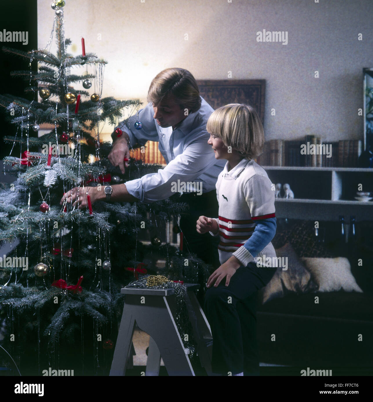 Christmas, Christmas tree / Christmas tree decorations, father with son decorating Christmas tree, 1980s, Additional-Rights-Clearences-Not Available Stock Photo