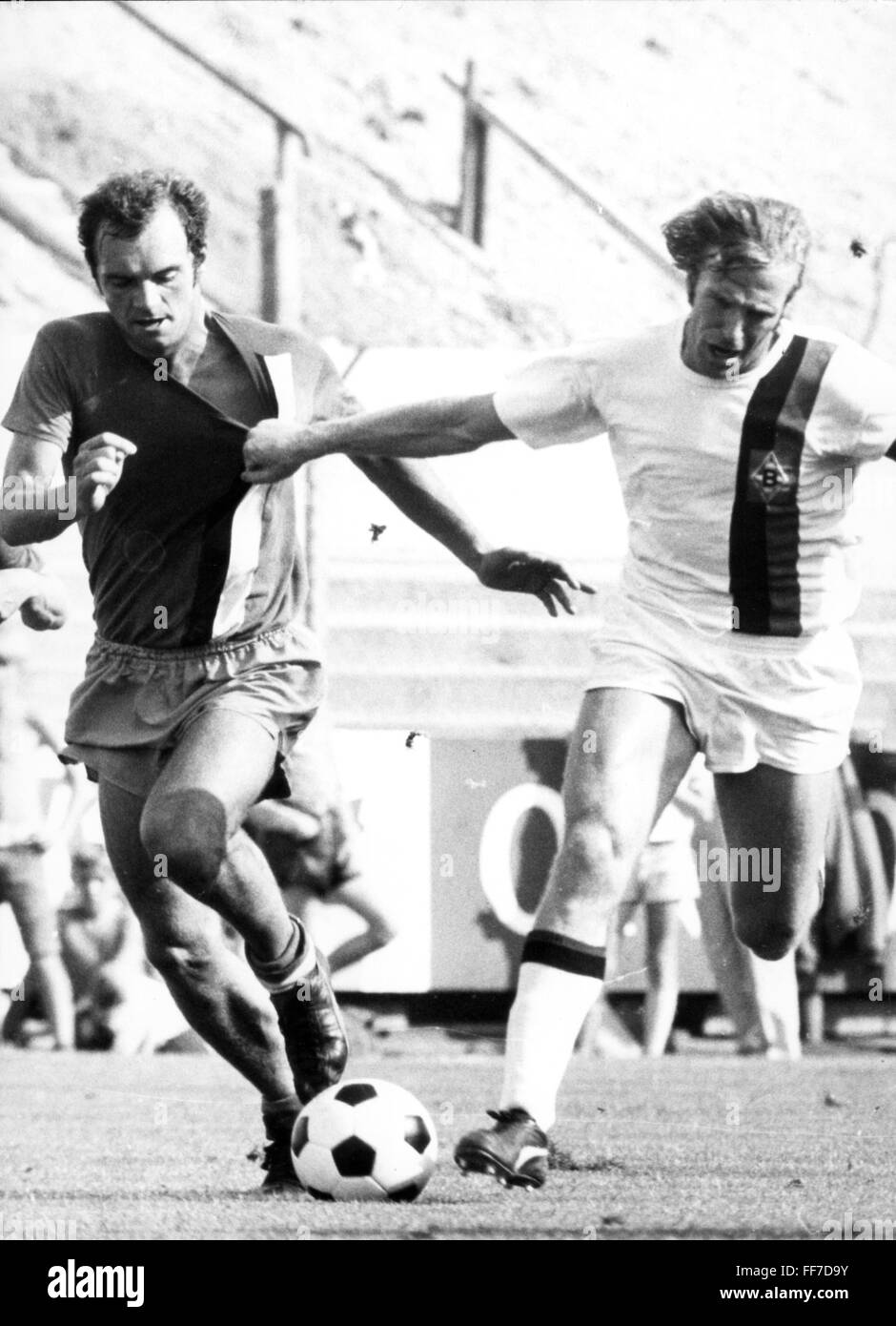 sports,football,game,Germany,national league,season 1971 / 1972,2nd match day,game Borussia Moenchengladbach versus Arminia Bielefeld(5:1),Boekelbergstadion,Moenchengladbach,21.8.1971,duel between Norbert Leopoldseder and Guenter Netzer,Bökelberg,football match,soccer match,football matches,athlete,athletes,football player,football players,footballer,footballers,kicker,player,players,ball,action,act,actions,acts,attack,offensive move,attacks,offensive moves,running,run,runs,playing,play,graps at the jersey,grab,grabbing,Additional-Rights-Clearences-Not Available Stock Photo