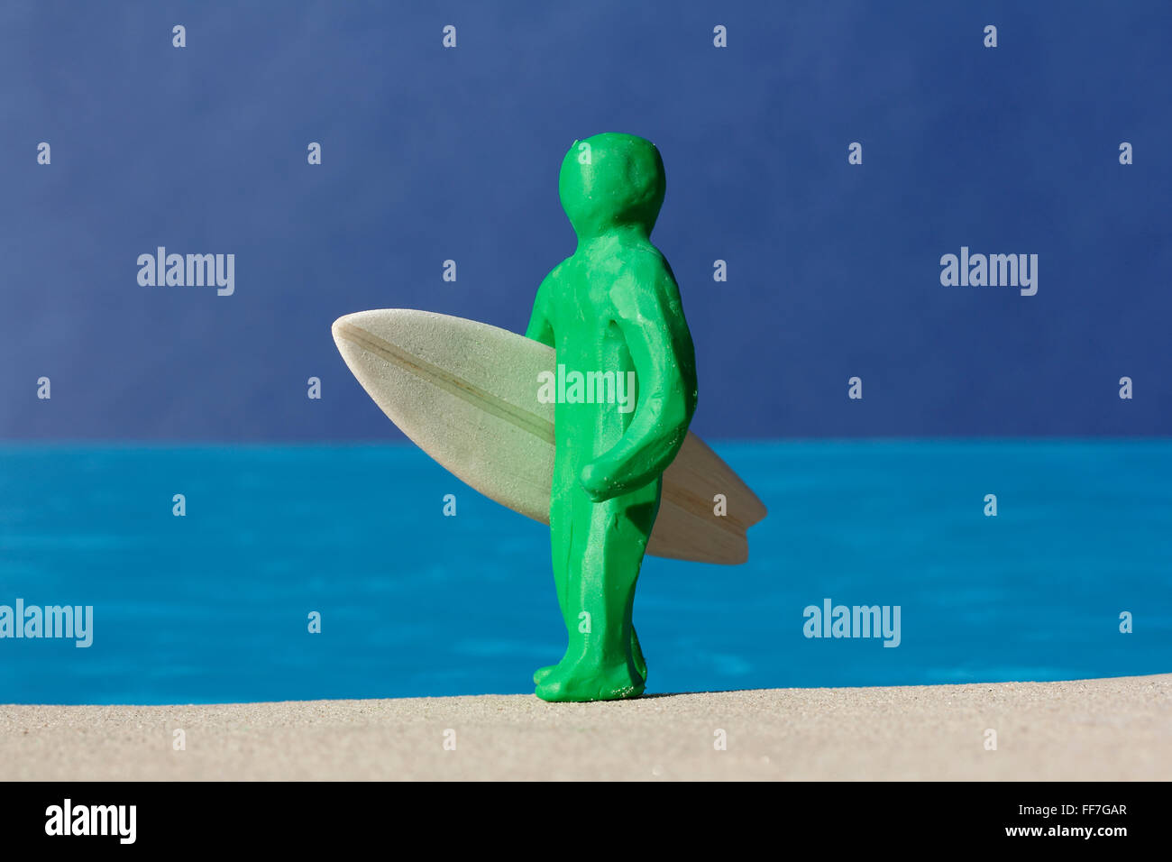 Plasticine Person and Balsa Surfboard. Stock Photo