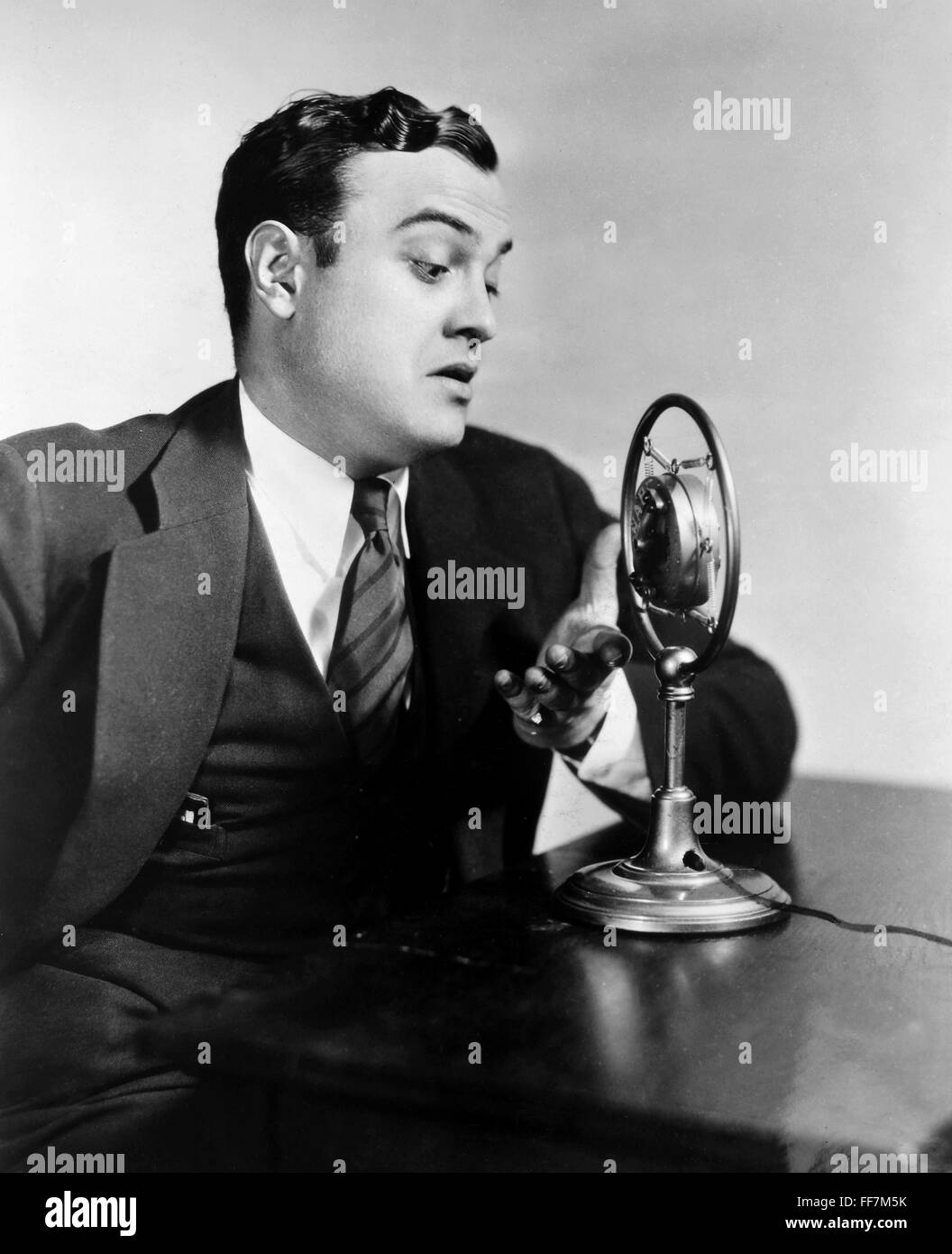 RADIO SHOW, 1930s. /nHenry Burbig of the Ceco Couriers program at a CBS microphone in the early 1930s. Stock Photo