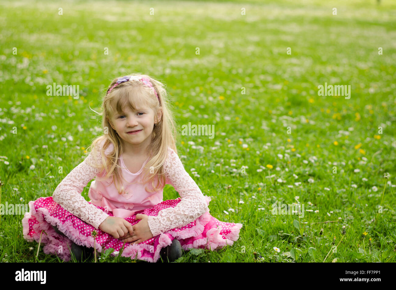 Adorable blond girl sitting in hi-res stock photography and images - Alamy