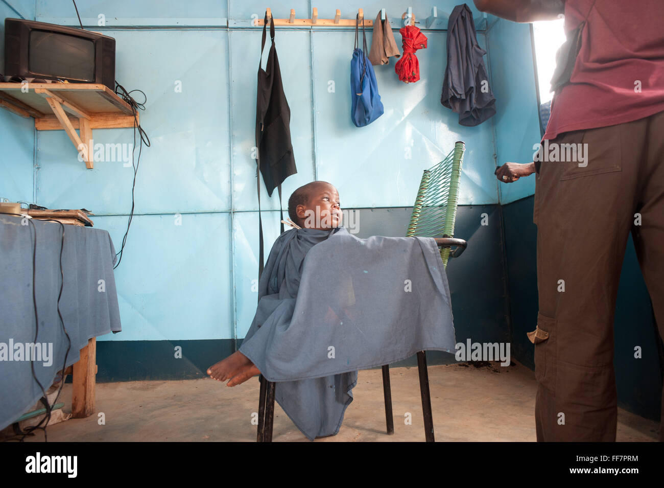 Mali, Africa - Black child getting his hair done in Africa Stock Photo