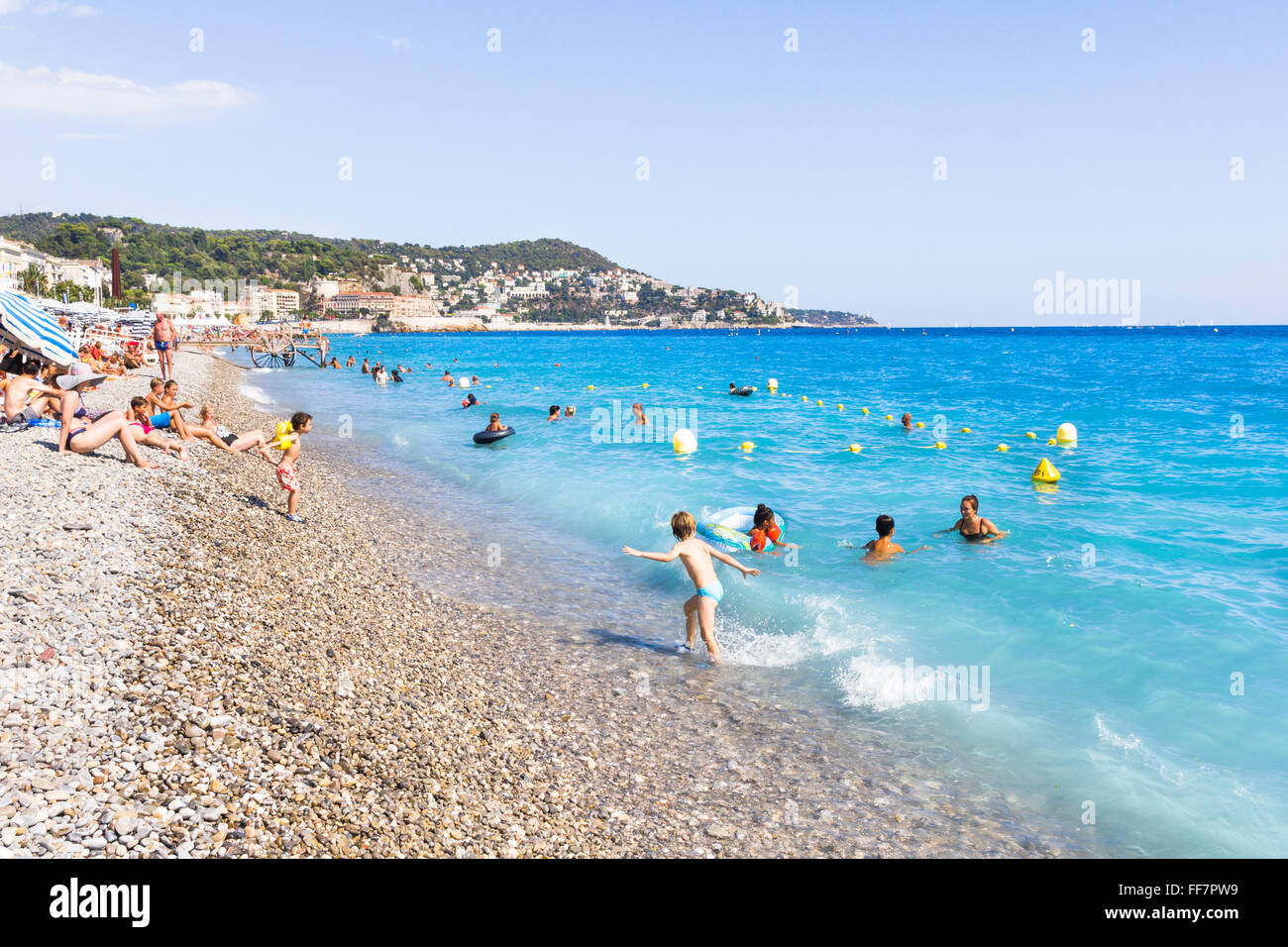 NICE, FRANCE - AUGUST 23: Tourists enjoy the good weather at the beach