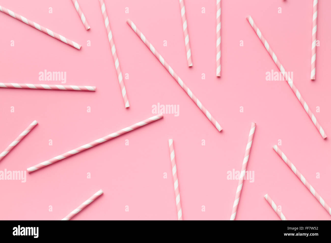 pink striped straws on pink background Stock Photo - Alamy