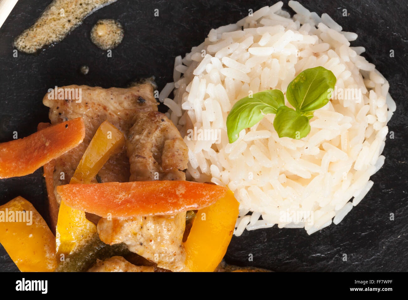 Slate Rice asian chicken dish on slate plate with rice Stock Photo - Alamy