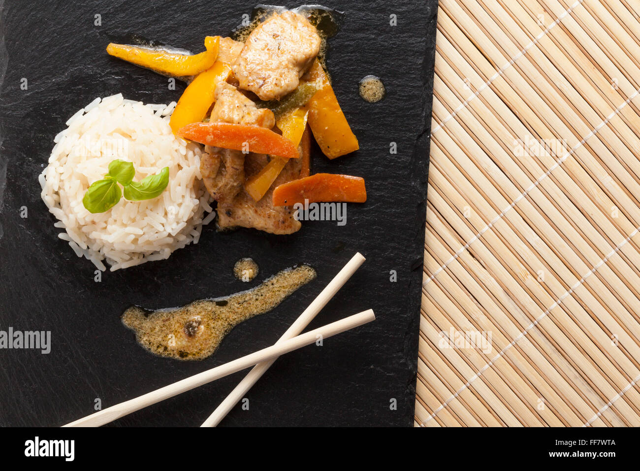 Slate Rice asian chicken dish on slate plate with rice Stock Photo - Alamy