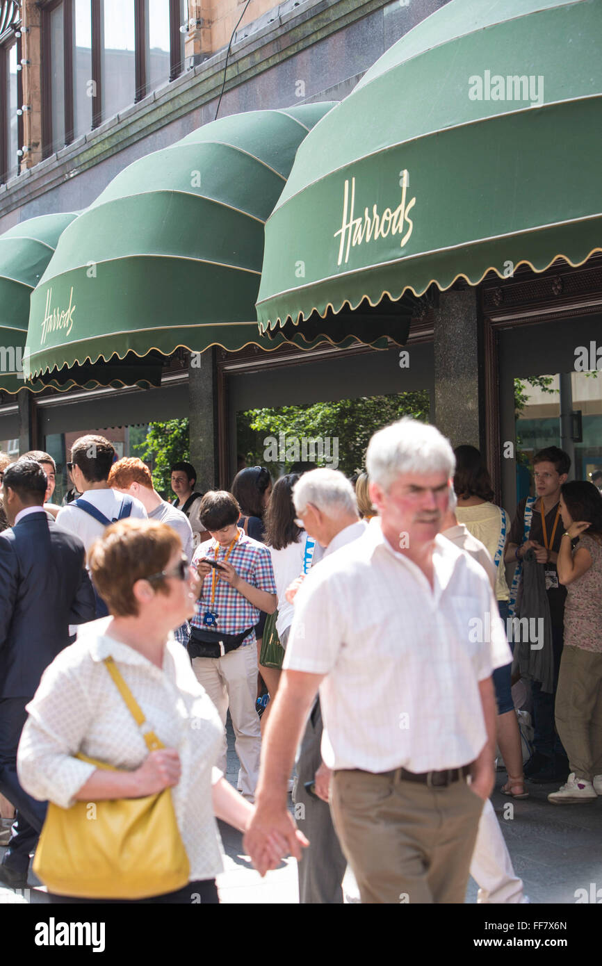 Shoppers and tourists outside the world famous Harrods department store in Knightsbridge, London, United Kingdom. Stock Photo