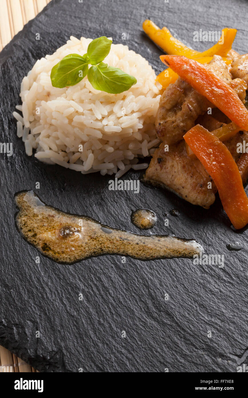 Slate Rice asian chicken dish on slate plate with rice Stock Photo - Alamy