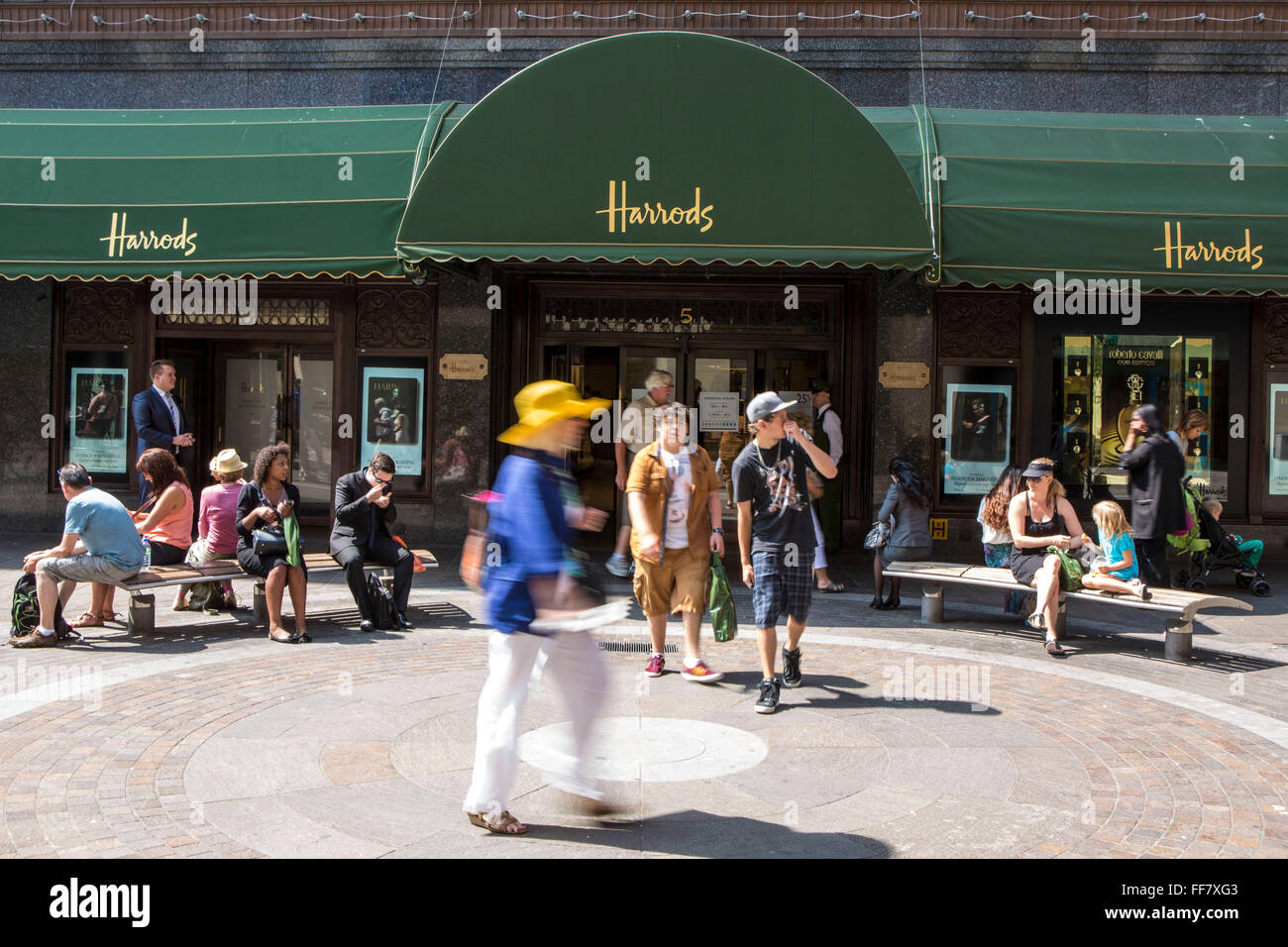Tourists shoppers exit the world famous retail store Harrods via door 5