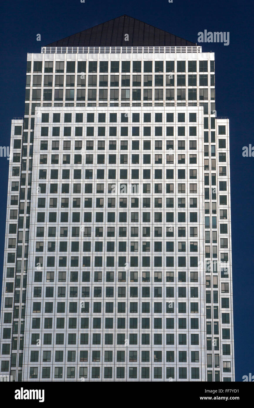Street view of One Canada Square, the second tallest skyscraper in United Kingdom. It is the second tallest building in the United Kingdom. One of the predominant features is the pyramid roof which contains a flashing light. The building is primarily used for offices and is a symbol of London’s financial sector and is surrounded with other business towers. Stock Photo