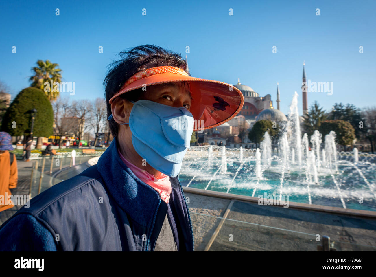 A Japanese tourist wearing a facemask near the Sultan Ahmed Mosque in