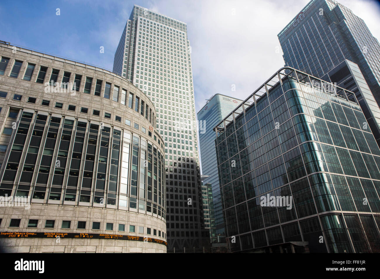 Street view from  of the iconic office buildings in the financial district of Canary Wharf, London, England, United Kingdom.   The famous One Canada Square skyscraper stands above the Thompson Reuters and Citi buildings. Stock Photo