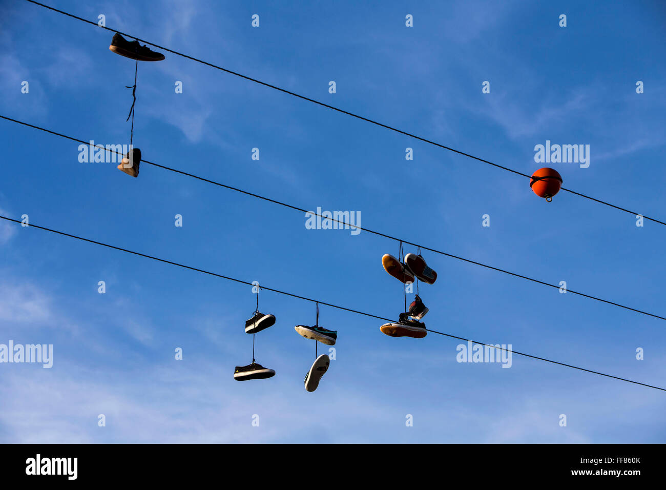 Pairs of shoes hanging on a wire. Wadebridge, Cornwall, UK. Shoe