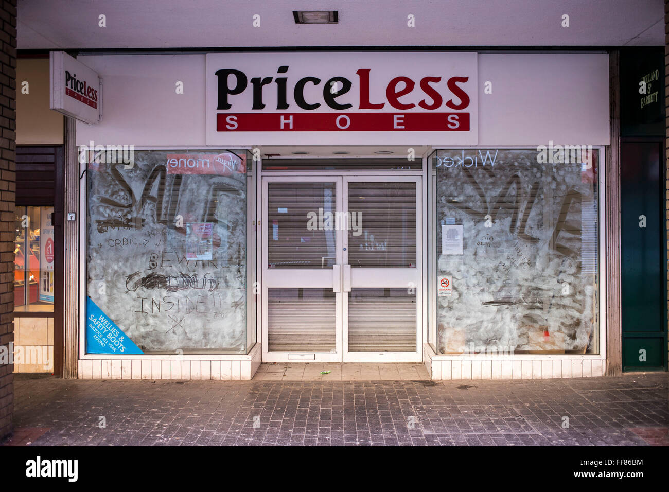 Closed down PriceLess Shoe shop in Middlesborough town centre, North Yorkshire, United Kingdom. Many small businesses have been forced to close during the economic slow-down. Stock Photo