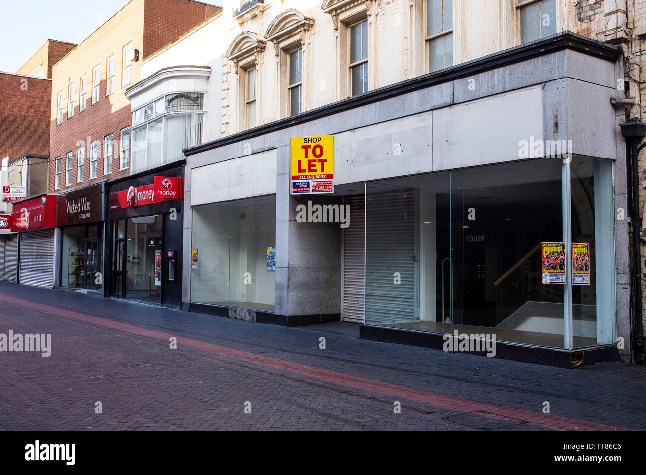 A large empty retail shop unit available to rent in Middlesborough town centre, North Yorkshire, United Kingdom. Many small businesses have been forced to close during the economic slow-down and estate agents are struggling to find new businesses to move in. Stock Photo
