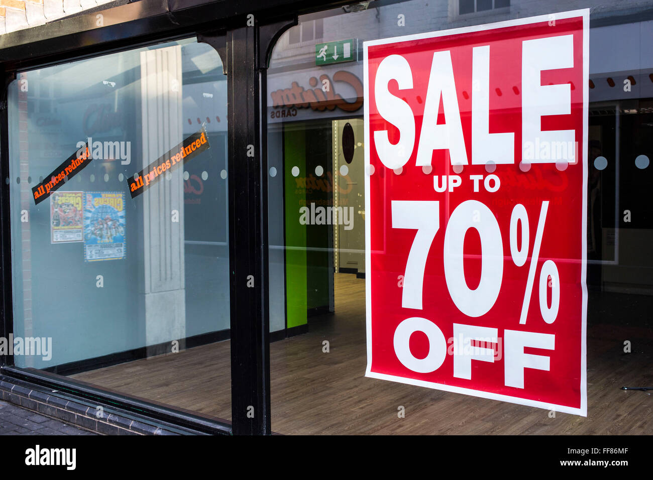 Shop window of an empty retail unit in Middlesborough town centre, North Yorkshire, United Kingdom.  The windows still have the sale signs on display with all prices reduced and up to 70% off. It was forced to close down due to the economic down-turn. Stock Photo