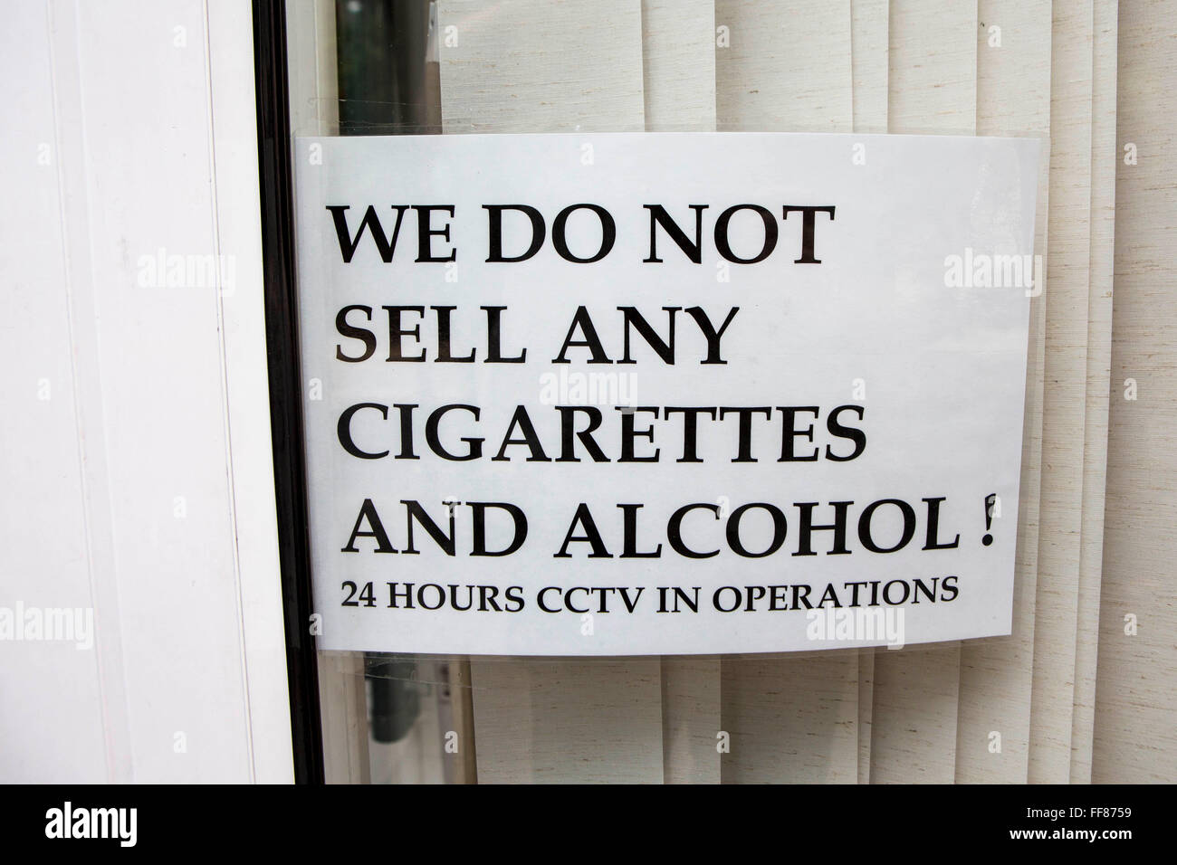 Window sign stating: We do not sell any cigarettes and alcohol! 24 hours CCTV in operation”. This is a warning sign to put potential break ins. London, UK. Stock Photo
