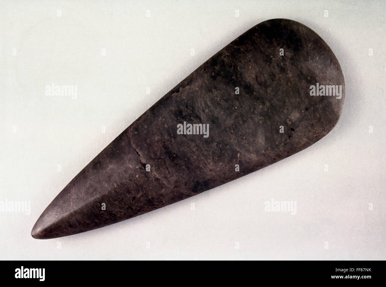NEOLITHIC AXE. /nHighly polished axe head of jadeite. Neolithic, c3000 B.C. 21.3 cm long. Stock Photo