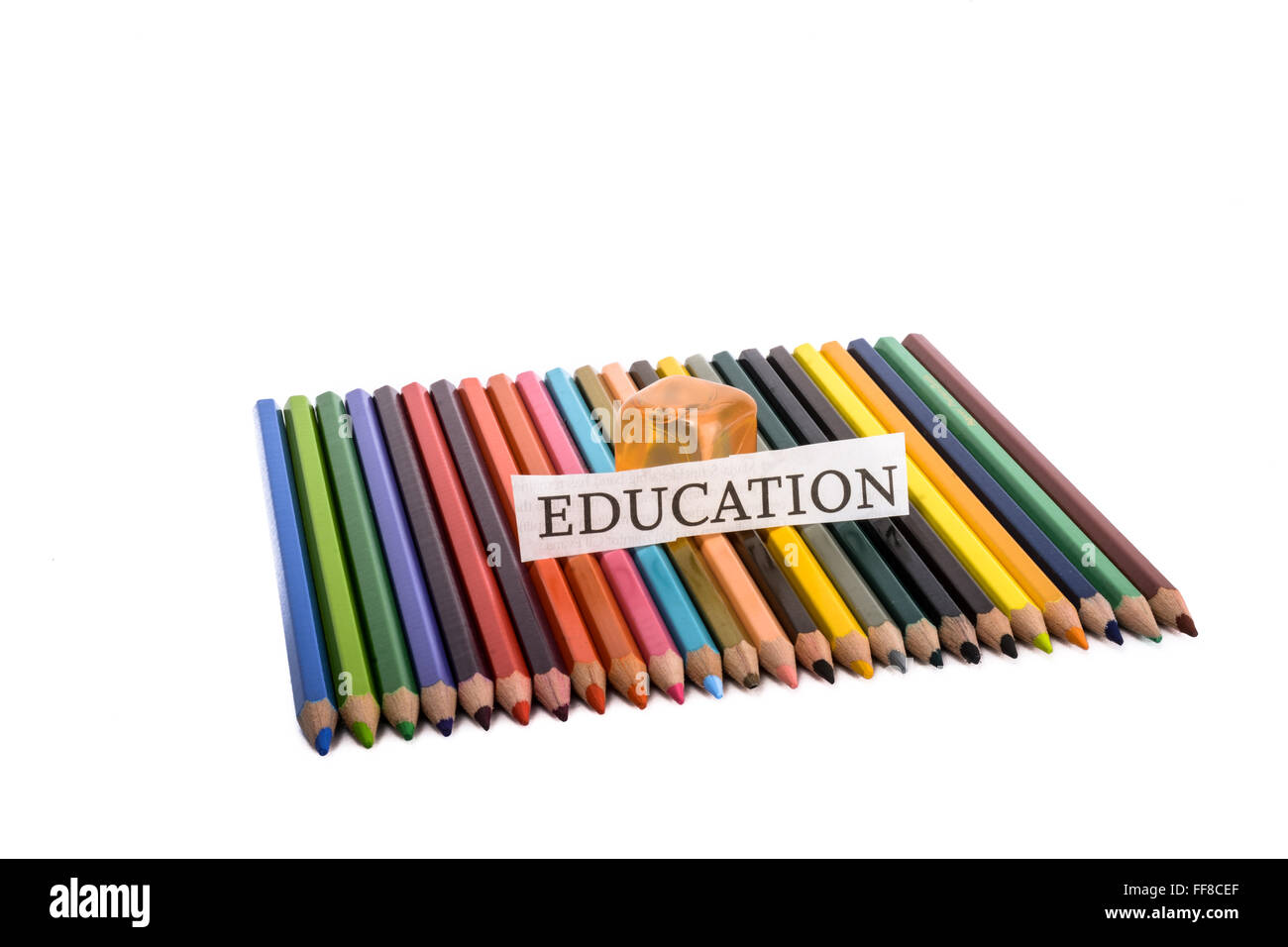 Colour pencils with  education note on them on a white background Stock Photo