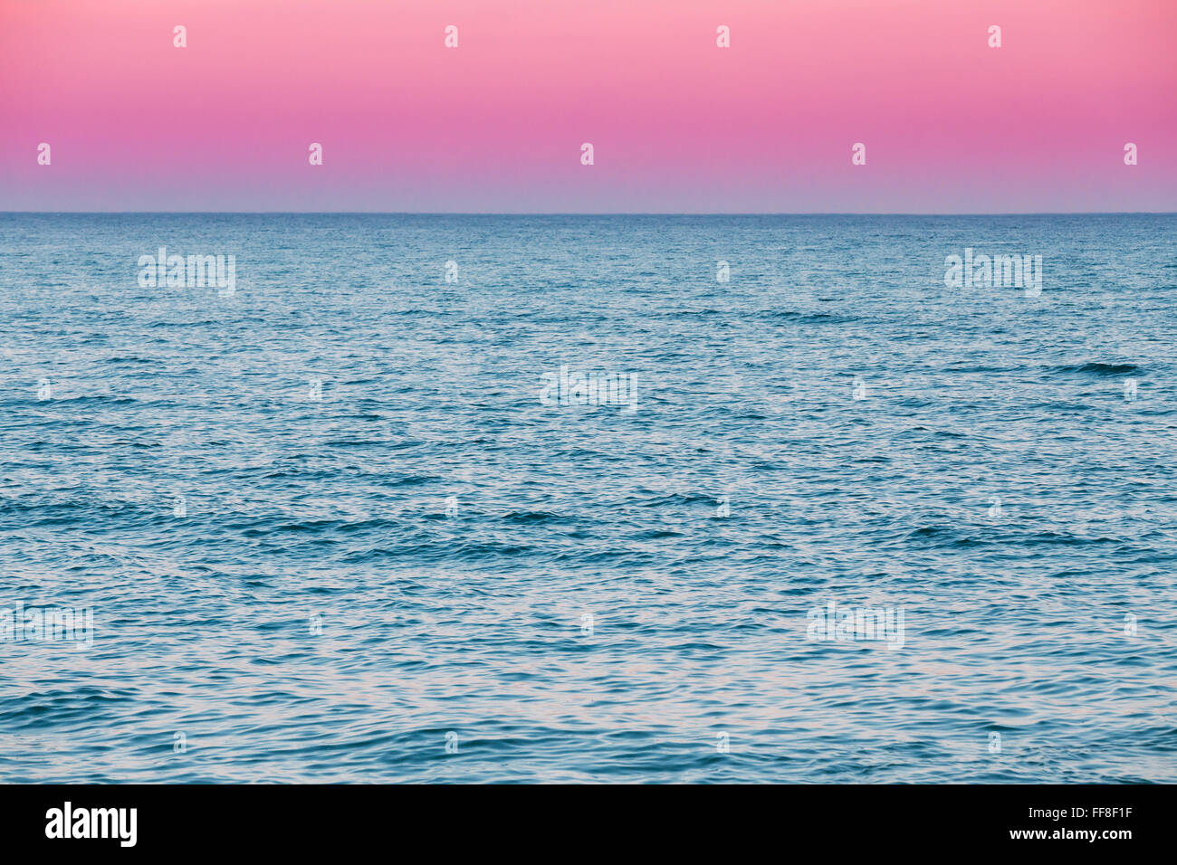 Calm Sea Ocean And Pink Red Sky Sunset Sunrise Background Stock Photo