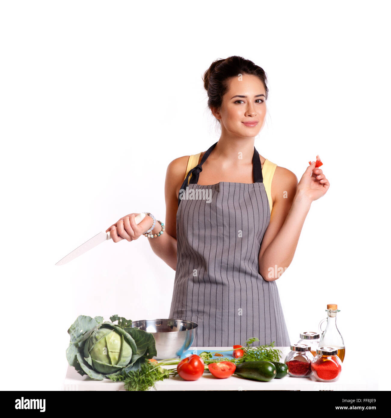 Young Woman Cooking in the kitchen. Healthy Food - Vegetable Salad. Diet. Dieting Concept. Healthy Lifestyle. Cooking At Home. P Stock Photo